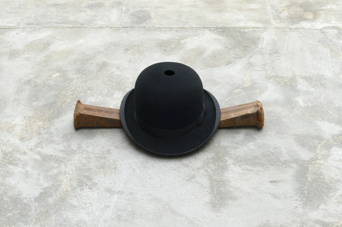 ‘A Mind Of Your Own [Golgotha]’ – 2020. felt (bowler hat), steel (wedges), 15,5 x 48 x 22,5 cm